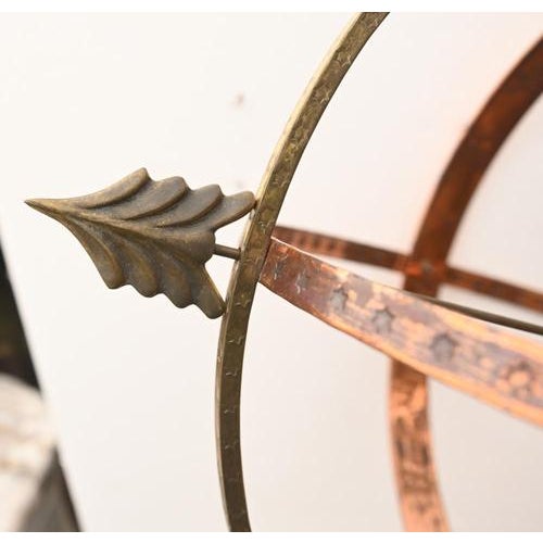Decorative brass armillary sphere mounted on stand Classical form with interlocking rings and arrow detail Nicely aged...