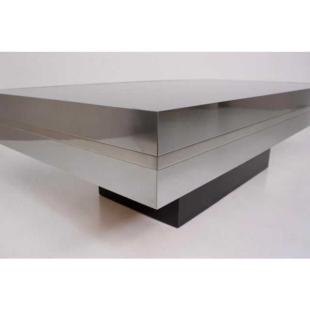 Coffee table, echoing the typical design of Italian tables from the 1970s. Its matte black laminate top contrasts with...