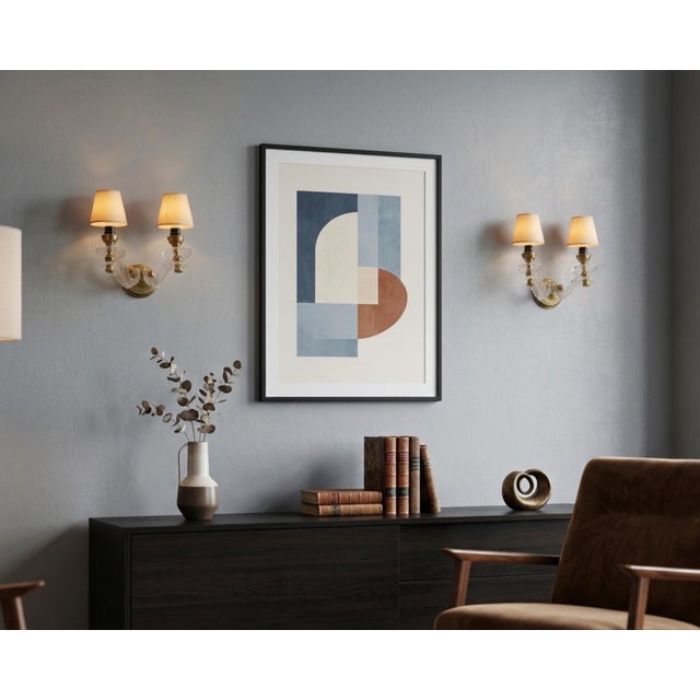 Pair of double-arm wall sconces dating to the 1970s. Clear moulded acrylic arms curve outward from round brass backplates...