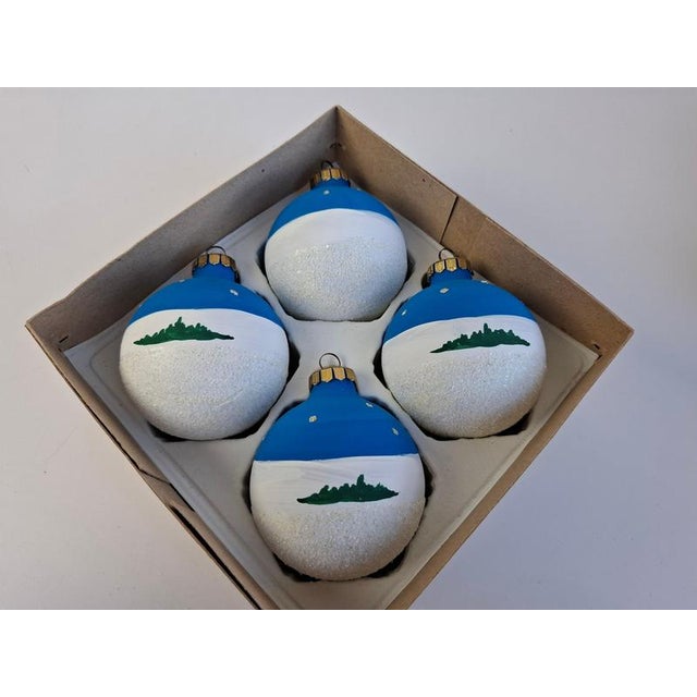 Charming set of four vintage German glass Christmas ornaments dating to circa 1980. Each spherical ornament is...