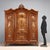 Late Baroque walnut wardrobe. Three-door paneled front, richly carved with scrolls, leaves, and curls; center door with...