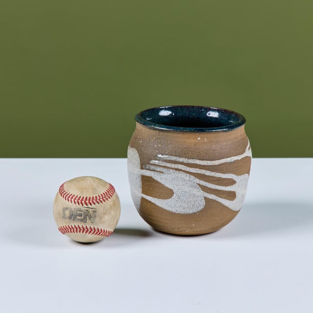 Hand thrown stoneware table planter. The planter features a stoneware exterior with a white drip glaze and the interior of...