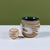 Hand thrown stoneware table planter. The planter features a stoneware exterior with a white drip glaze and the interior of...