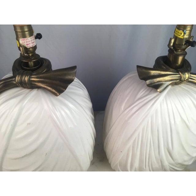 Beautiful pair of draped ceramic lamps with brass bow Details. Vintage Chapman!