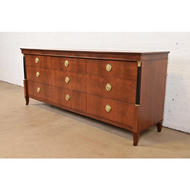 An exceptional French Empire or Neoclassical style triple dresser or chest of drawers By Baker Furniture USA, Circa 1960s...