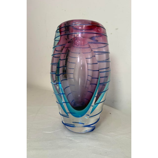 This vintage hand-blown Italian Murano glass vase is a stunning piece of studio glass that showcases the craftsmanship and...