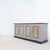 A low sideboard dating from the early 20th century, preserved in a beautiful antique patina of beige, gray, and black...
