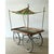 This vintage market cart is built as a functional wheeled platform, with a wide, flat wooden tabletop framed in a simple...