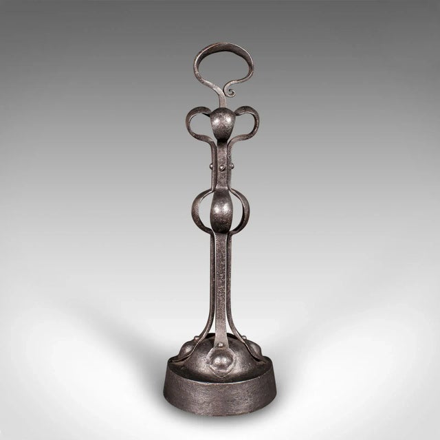 This is an antique Arts & Crafts doorstop. An English, wrought and cast iron door keeper in the manner of Liberty of...
