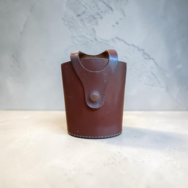 Offering a vintage English rigid rawhide travel case for a hip flask. Mid-century British makers designed these hard-...