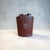 Offering a vintage English rigid rawhide travel case for a hip flask. Mid-century British makers designed these hard-...