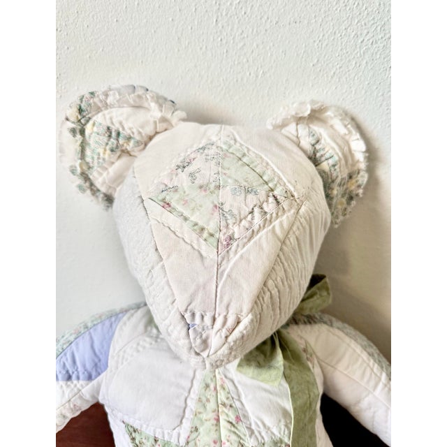 Charming vintage handmade patchwork teddy bear, crafted from softly worn quilt and floral cotton fabrics in a palette of...