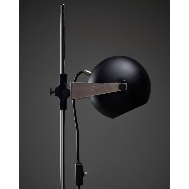 Adjustable Space Age Black & Chrome "Eyeball" Floor Lamp from the 1960s. Enhance your reading nook with this sleek,...