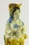 An UNUSUAL early glazed terracotta figurine It depicts a girl or young woman in somewhat pastoral attire, Provençal...