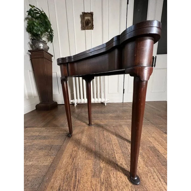 Flip top George II style games table on pad feet. Very good condition overall. Some signs of historic woodworm to the...