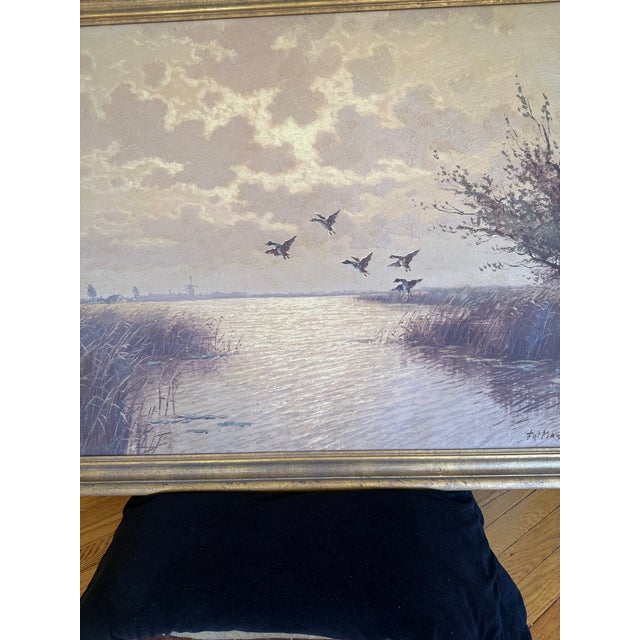 Wonderful mid century landscape of Canadian Geese landing on pond with sunset in background by Fritz Martens...