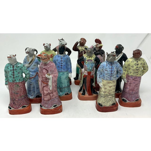 An amazing complete twelve-piece set of Famille Rose Zodiac Figures. Standing figures in colorful robes representing...