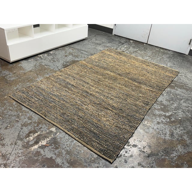 Design Plus Gallery presents a 5f t1in × 8ft 2in Textured Woven Area Rug from Crate & Barrel. The rug offers you an earthy...