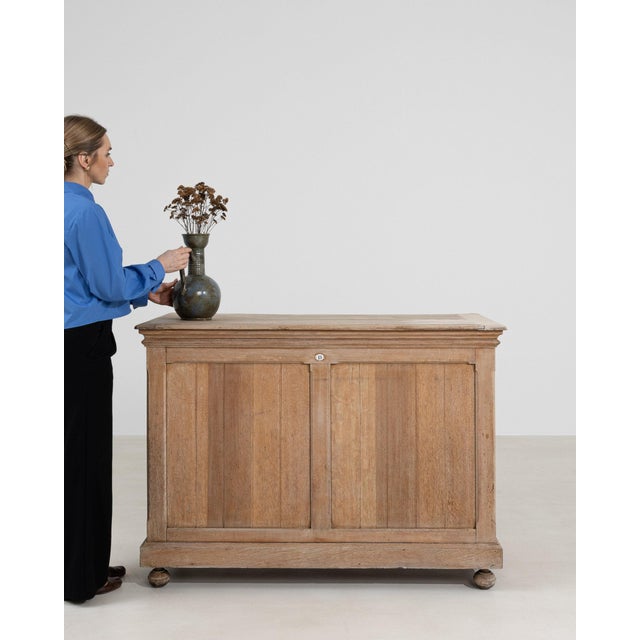 This piece presents as a cabinet, distinguished by natural bleached oak, stepped profile. It was made in France during...