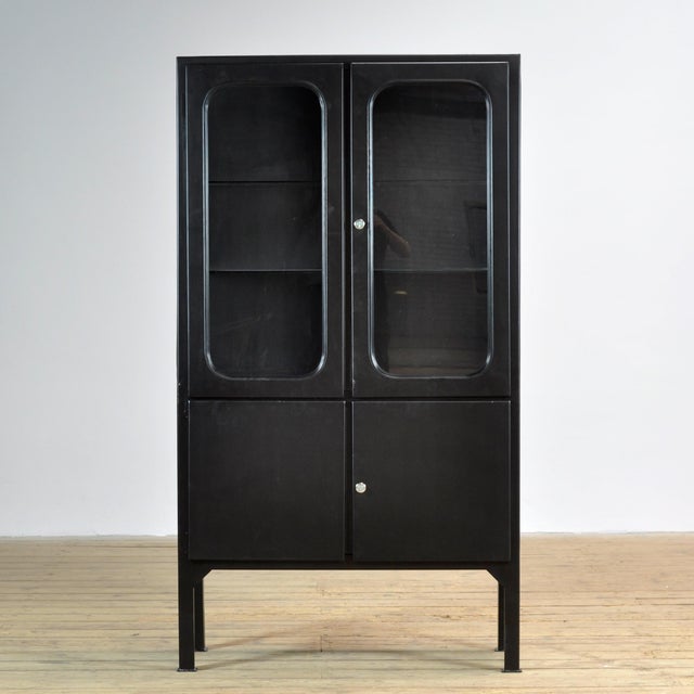 Medicine cabinet from the 1970s, originally from a Hungarian hospital. The cabinet is made of iron and features glass...