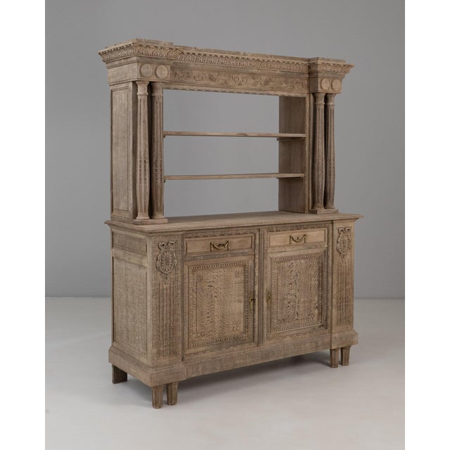1910s Belgian Renaissance Revival Oak Cupboard With Carved Columns. This impressive cupboard is richly detailed,...