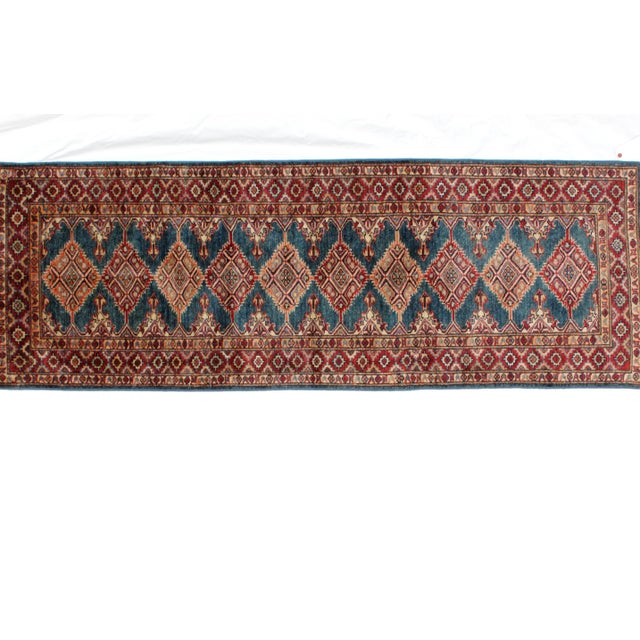 This is a Leon Banilivi Ghazni Khotan runner. The piece is handwoven from wool.