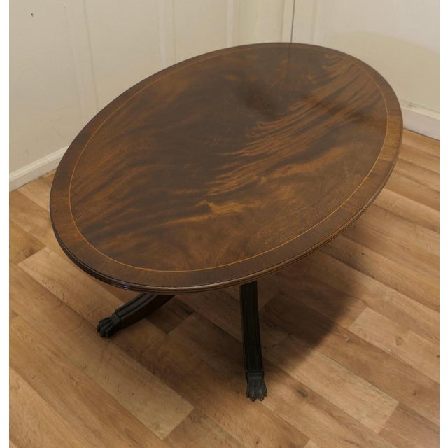A large Regency Style flame mahogany coffee table. This is a very attractive piece, it is made in the style of an Oval...