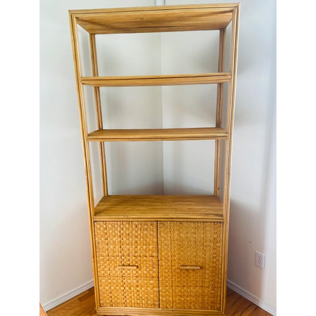 Beautiful bamboo Rattan and Wicker shelf/ bookcase with a lot storage space. Features slicer cabinet door and shelving....