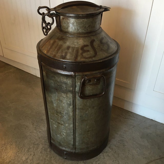Very cool original antique metal milk can. It has all the original parts all in heavy gage metal. It has remnants of...