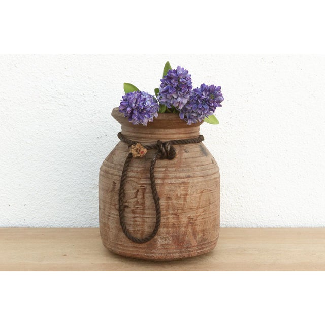 Originally used in village homes for storing milk, ghee, or grains, this antique wooden pot has survived generations of...