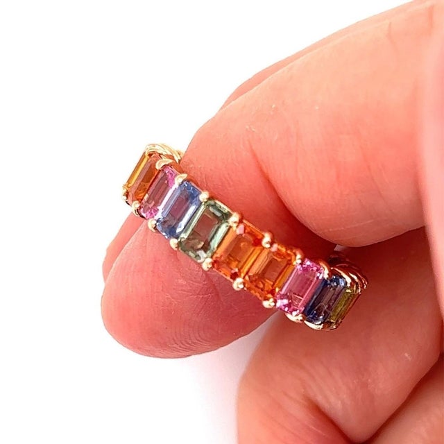 This 18k Rose Gold Full Circle Emerald Cut Multi-Color Sapphire Band Ring in size 6.5 is a stunning piece of vintage and...