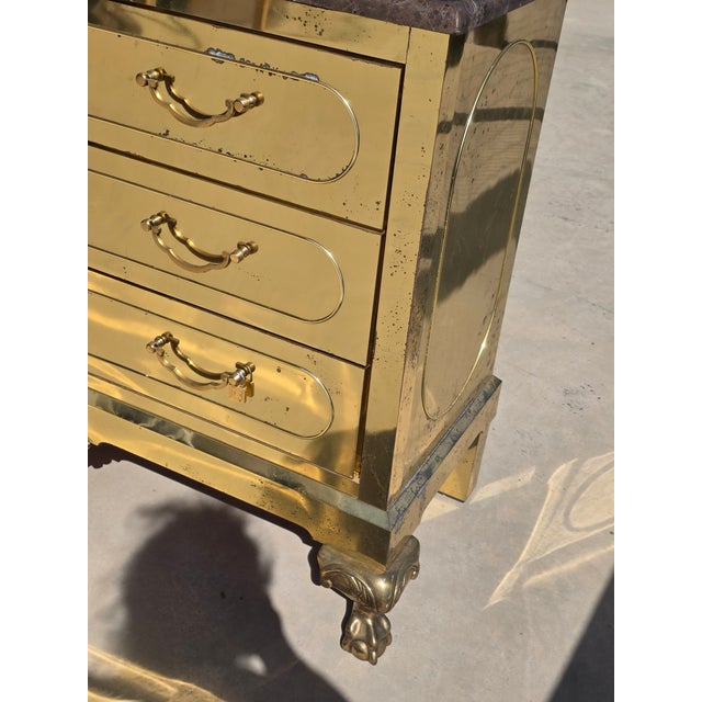 Great looking vintage 1980"s brass Clad chest of drawers with a brown marble top. Unusual claw and ball feet and shell...