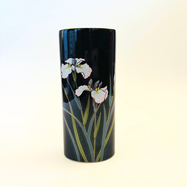 A beautiful vintage ceramic vase. Glossy black finish with a design of iris flowers on the surface. Gold rim. Tall oval...