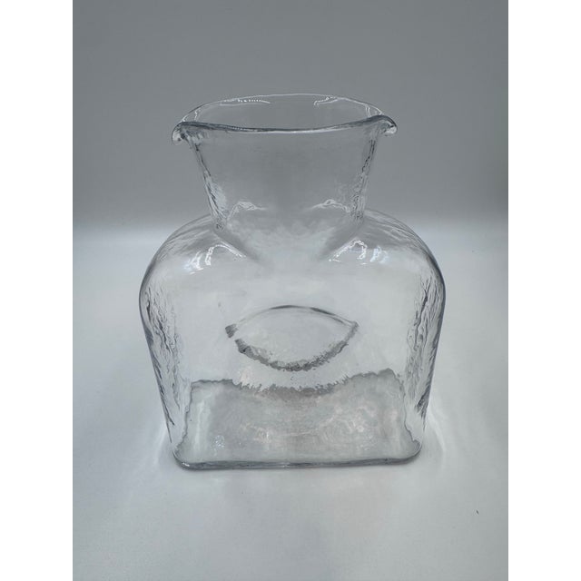 Striking vintage Blenko hand-blown glass water bottle, pattern No. 384, featuring the iconic free-form silhouette for...