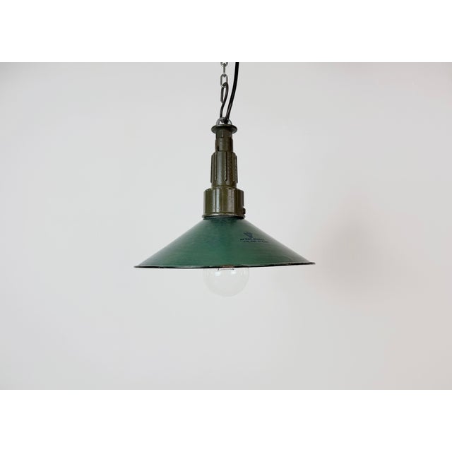Industrial green enamel pendant light made in Poland during the 1960s. White enamel inside the shade. Green cast aluminium...