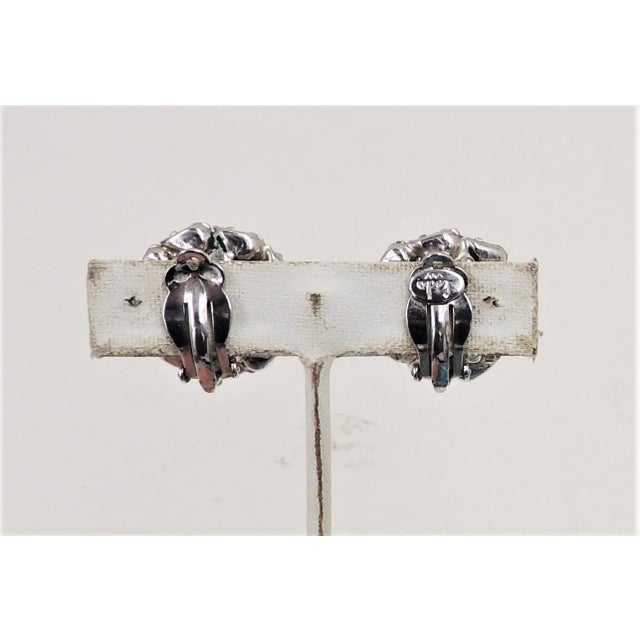 This is part of Chairish’s Costume Jewelry assortment. Vintage 1950s rhodium plated prong set center square cut faux-...