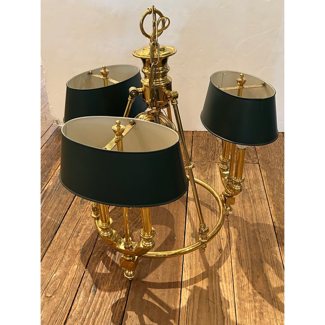 Handsome Lightolier polished brass bouillotte style chandelier having 3 arms with dark green tole shades. (Nobbs)