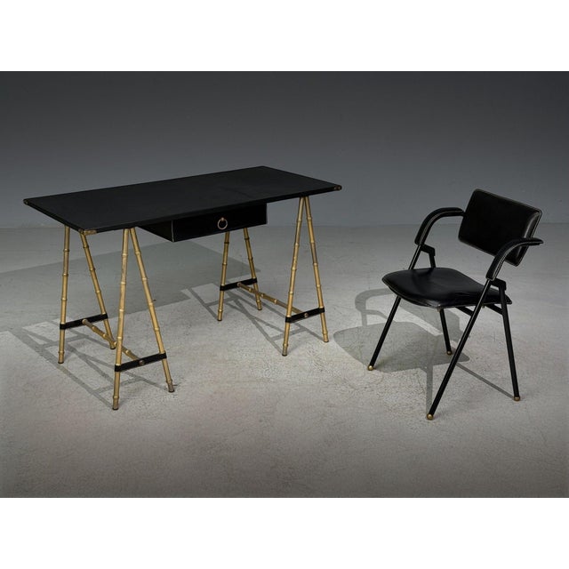 Jacques Adnet atrribution, Desk and Folding Chair Set, Black Leather, Brass, France, 1950s A wonderful desk attributed to...