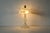 Vintage Art Nouveau-style frosted glass table lamp featuring a molded floral relief shade and matching frosted glass base....