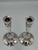 Elegant pair of early 20th-century sterling silver candlesticks, distinguished by their slender, elongated proportions and...