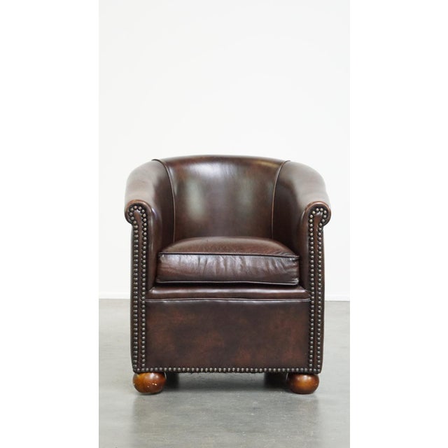 A beautiful luxurious dark cowhide club chair with ball legs in English style. This comfortable cowhide leather club chair...