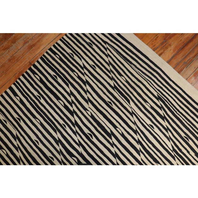One of a kind modern Persian Kilim in black and white with a zebra-like motif Measures: 8'6" x 11'4".