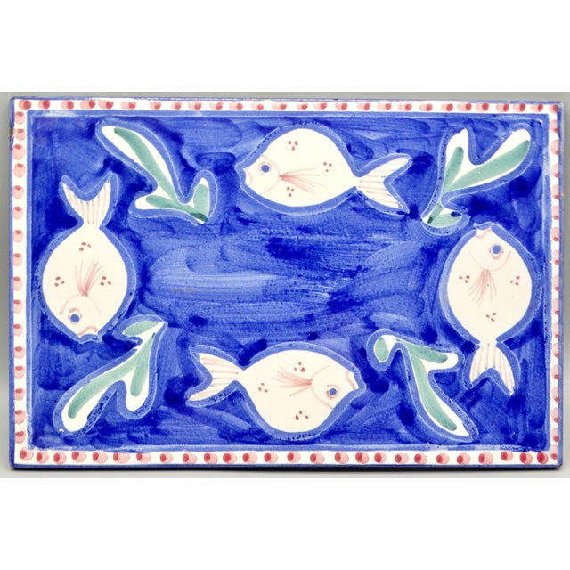 Vintage Italian tile trivet with hand painted swimming fish. This lovely tile has a bright colorful design and would be...