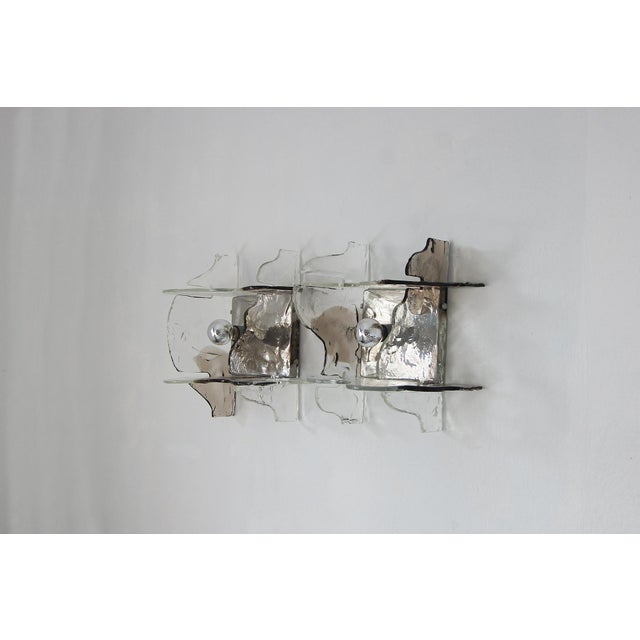 This wall lamp designed by Carlo Nason is a striking and elegant light fixture that will add luxury to any space....