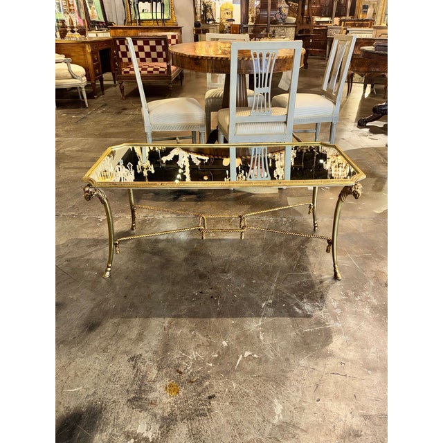 The Italian Maison Bagues Design Gilt Brass Coffee Table is a luxurious and stylish piece of furniture for any home. This...