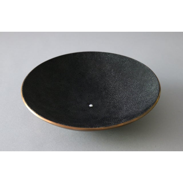 A striking low decorative bowl combining spun copper with a genuine black stingray shagreen interior. A single pearl is...