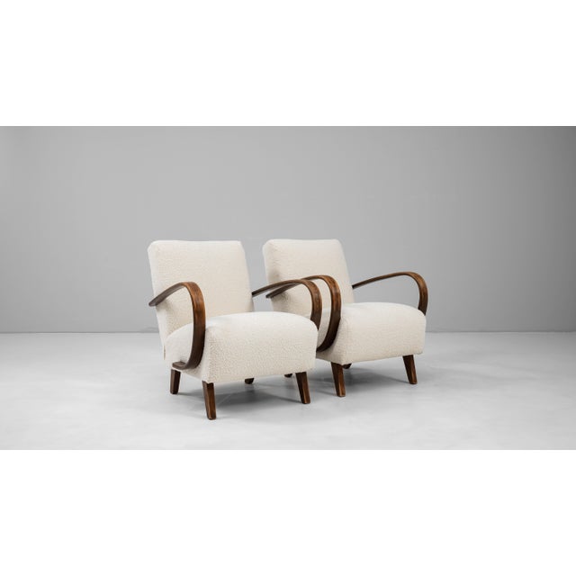 This pair of 1950s Czech Wooden Armchairs by J. Halabala exemplifies mid-century modern design with their signature blend...