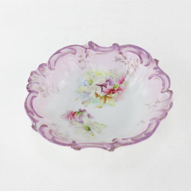 This Victorian-inspired porcelain plate showcases a rich purple and white palette with hand-painted floral details. The...