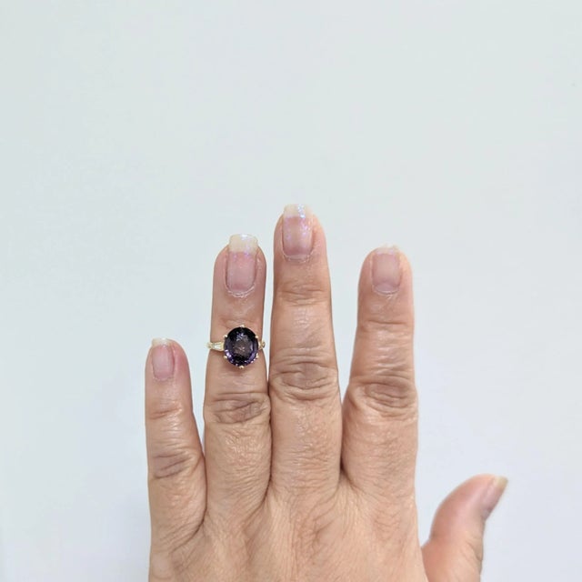 Gorgeous 4.51 ct. purple spinel oval with 0.20 ct. good quality white diamond baguettes on either side. Handmade in 14k...