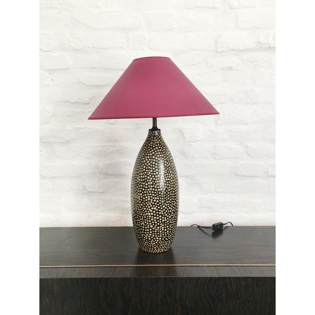 A striking handcrafted ceramic table lamp featuring an elegant elongated baluster form, decorated with an all-over...